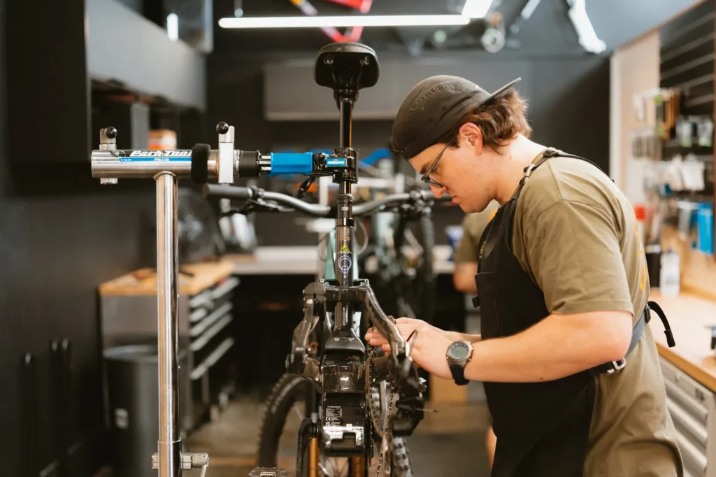 Outset mechanic servicing a Forbidden e-bike motor and drivetrain