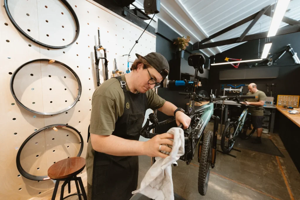Outset mechanic servicing a mountain bike in the Auckland workshop